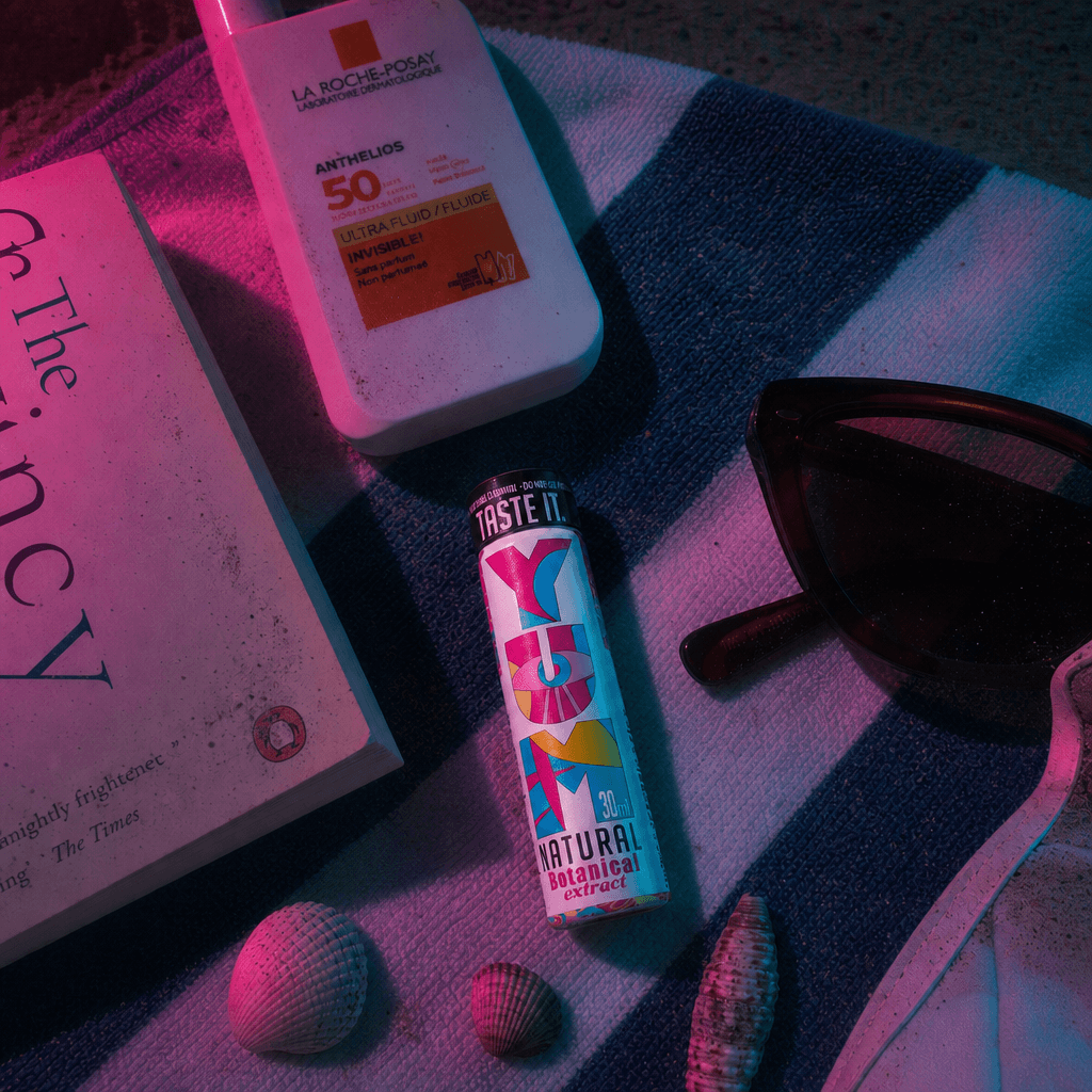 YUM on a beach towel under neon light